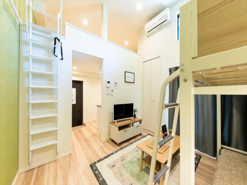 a room with a loft bed and a tv at TRIP POD MINOSHIMA A in Fukuoka
