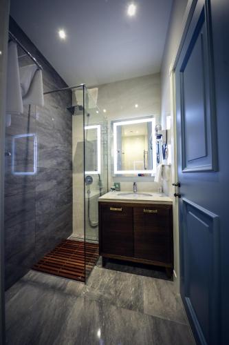 a bathroom with a sink and a shower with a glass door at Hotel Centar No.1 in Belgrade