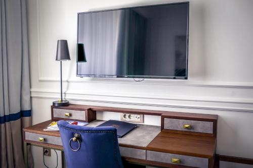 a desk with a blue chair and a large mirror at Hotel Centar No.1 in Belgrade