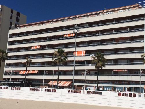 a large white building with palm trees in front of it at Luxury Oceanfront triplex in Cadiz in Cádiz