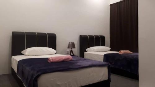 a bedroom with two beds with pillows on them at COMFORTABLE STAY in Ayer Itam