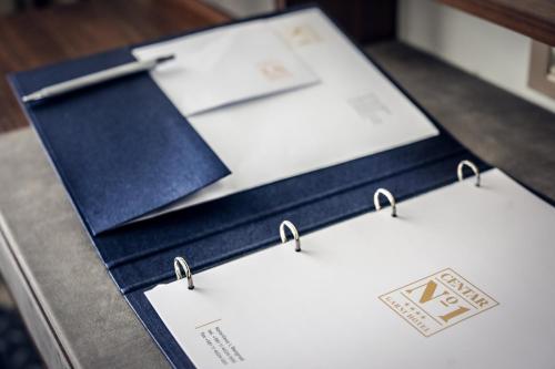 a table with three sheets of paper on it at Hotel Centar No.1 in Belgrade