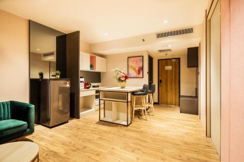a kitchen and living room with a table and chairs at TROVE Johor Bahru in Johor Bahru