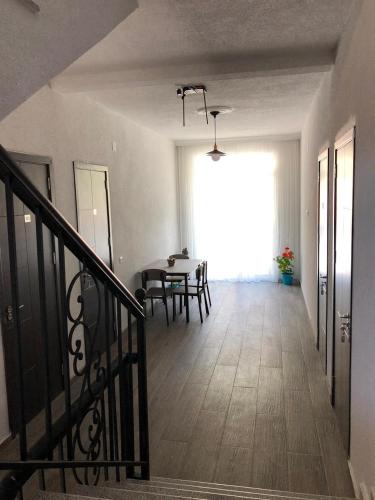 a hallway with a table and a dining room at Hotel CHARLI in Gonio