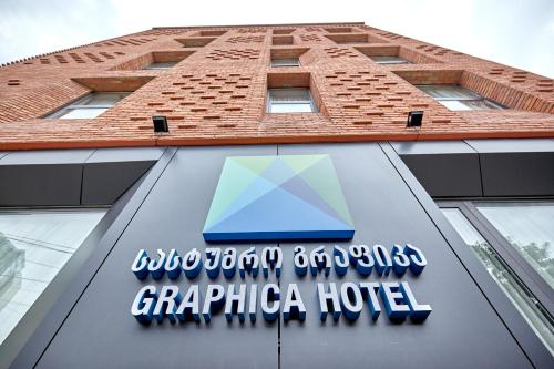 a sign for a grpica hotel on the side of a building at Graphica Tbilisi Hotel in Tbilisi City