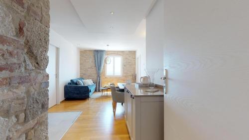 a kitchen and living room with a stone wall at Riva Apartments in Split