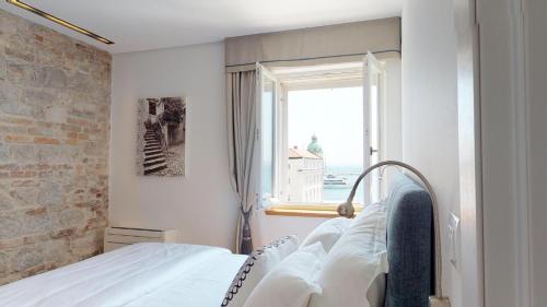 a bedroom with a bed and a window at Riva Apartments in Split