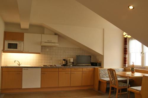 a kitchen with a counter top and a table at Haus Venetblick in Wenns