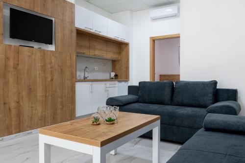 a living room with a couch and a table at APARTMANI JUDIK in Neum