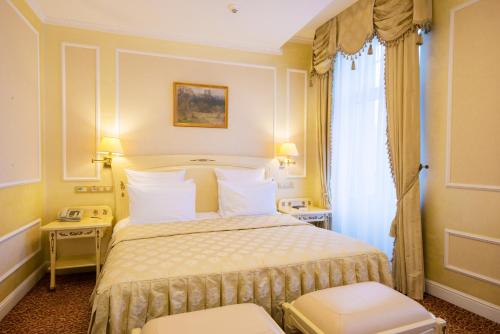a hotel room with a bed and a window at Europe Hotel in Minsk