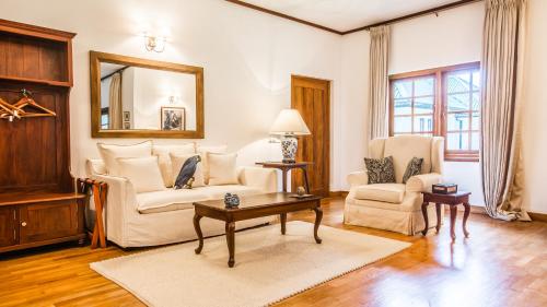 a living room with a couch and a table at Thotalagala in Haputale