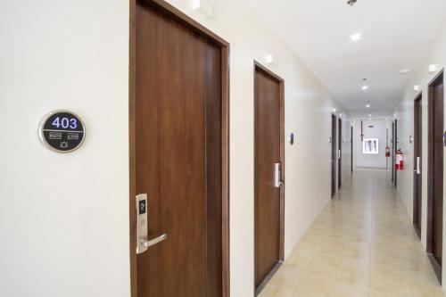 a hallway of a hospital with a clock on the wall at 18 Suites Cebu in Cebu City