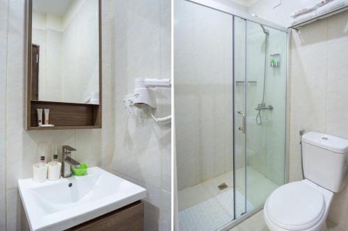 a bathroom with a toilet sink and a shower at 18 Suites Cebu in Cebu City