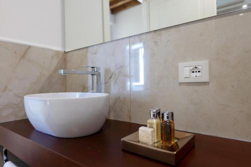 a bathroom with a white bowl sink on a counter at Residenza Palazzo Fortuna - Boutique Hotel in Civita Castellana