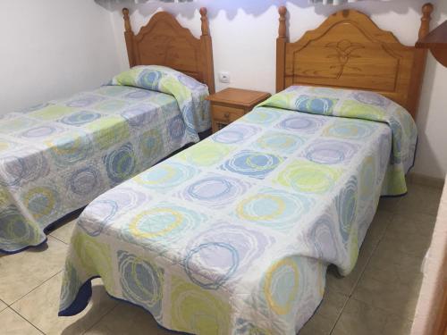 two beds sitting next to each other in a room at Apartamentos Teror - Gavias del Sol in Playa del Ingles