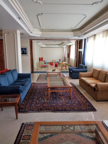 a living room with blue couches and a table at Vergina Hotel in Thessaloniki