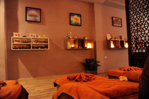 a room with two beds and shelves on the wall at Hanoi Golden Sunshine Villa Hotel and Travel in Hanoi