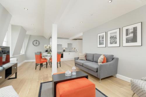 a living room with a couch and a table at Destiny Scotland Hanover Apartments in Edinburgh