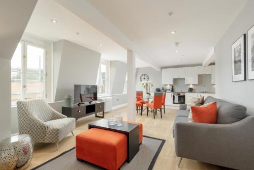 a living room with a couch and a table at Destiny Scotland Hanover Apartments in Edinburgh