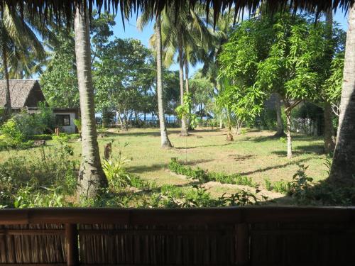 a view from the porch of a resort with palm trees at Sugar Lounge Lodge in Nauhang
