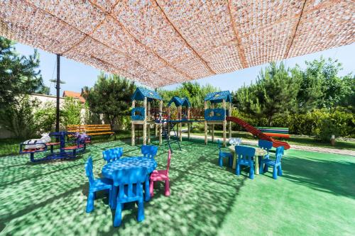 a playground with colorful chairs and a slide at Kompleks Otdykha Elki-Palki in Odesa