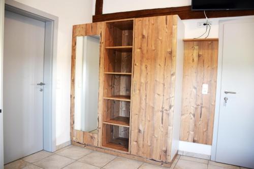a wooden closet with a door in a room at Apartment´s Marchtrenk in Marchtrenk