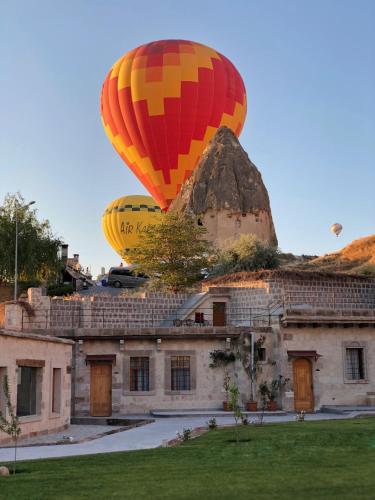 a hot air balloon flying over a building at Lunar Cappadocia Hotel in Goreme