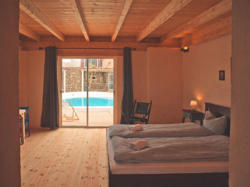 a bedroom with a bed and a swimming pool at Bungalow - Fuego - Surf & Yoga Villa in La Pared
