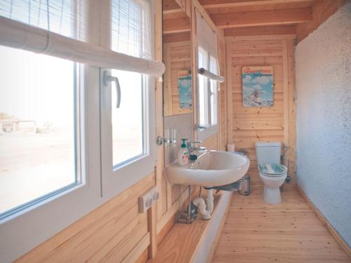 a bathroom with a sink and a toilet at Bungalow - Fuego - Surf & Yoga Villa in La Pared