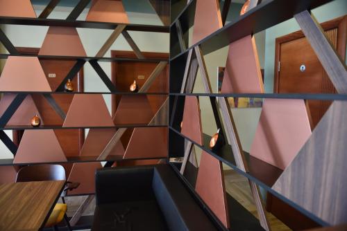 a wall with pink and black triangles at Prior Hotel in Prizren