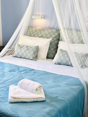 a bed with a towel on top of it at Elena Studios & Apartments in Piso Livadi