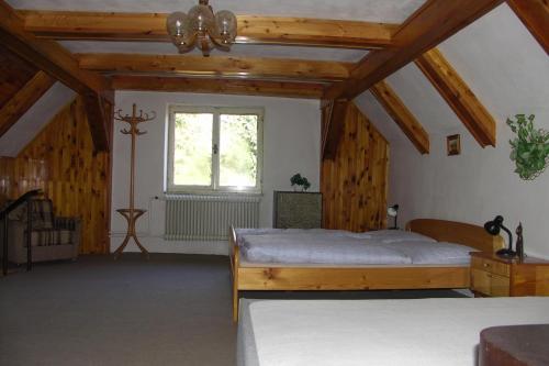 a bedroom with a large bed and a window at Edy Dum in Svoboda nad Úpou