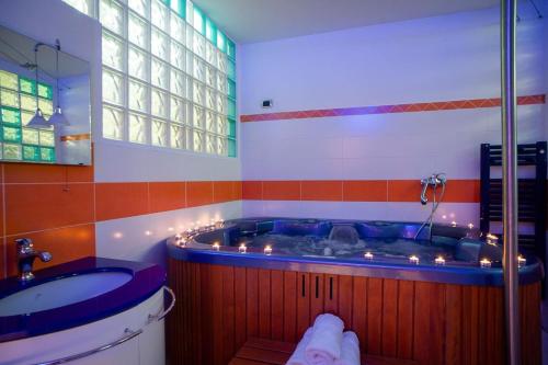 a large bathroom with a tub and a sink at Villa Sequoia in Leinì