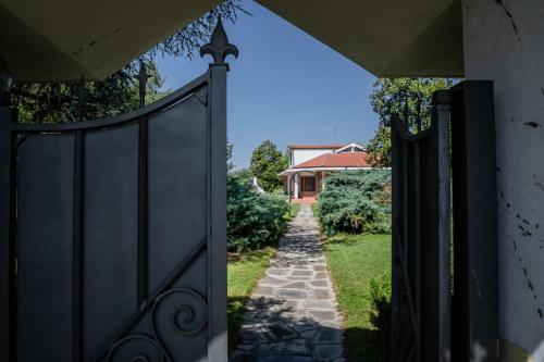 an entrance to a house with a black gate at Villa Sequoia in Leinì