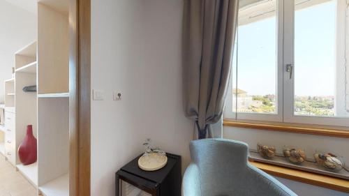 a living room with a chair and a window at Riva Apartments in Split