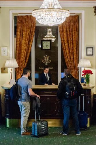 two men standing in front of a podium with a man in a suit at Londonska SPA Hotel in Odesa
