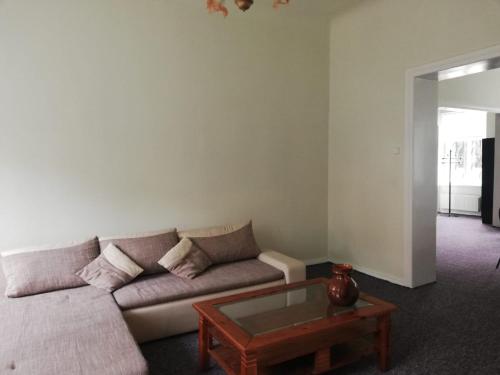 a living room with a couch and a coffee table at Figaro in Ventspils