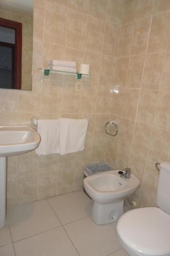 a bathroom with a toilet and a sink at Luxmar Apartaments in Benidorm