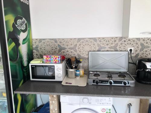 a kitchen counter with a microwave and a toaster oven at Pensiune Aymar in 2 Mai