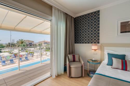 a hotel room with a bed and a balcony at Grand Hotel & Riviera in Lido di Camaiore