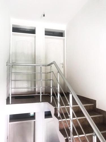 a staircase with a metal railing in a building at Mountain House Tara Apartmani Nikolic in Kaludjerske Bare