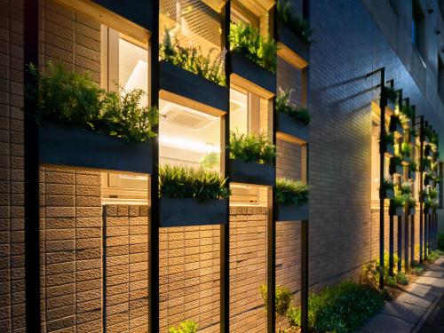 a building with plants on the side of it at Super Hotel Tottori Ekimae in Tottori
