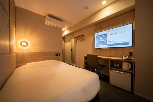 Postel nebo postele na pokoji v ubytování Super Hotel Tottori Ekimae