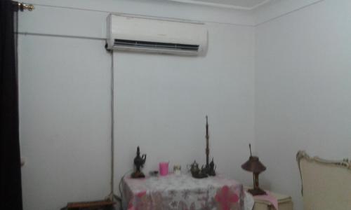 a room with a table and a air conditioner on the wall at Smoha Zahran Haus (Private rooms or Private Apartment) in Alexandria