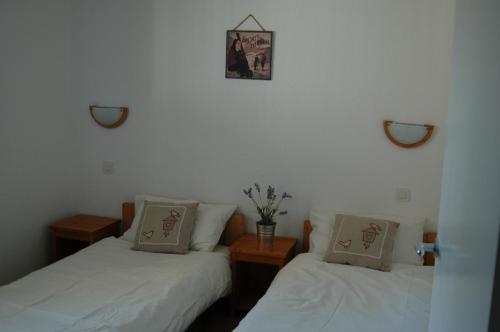 a room with two beds and a picture on the wall at Saboia in La Tania