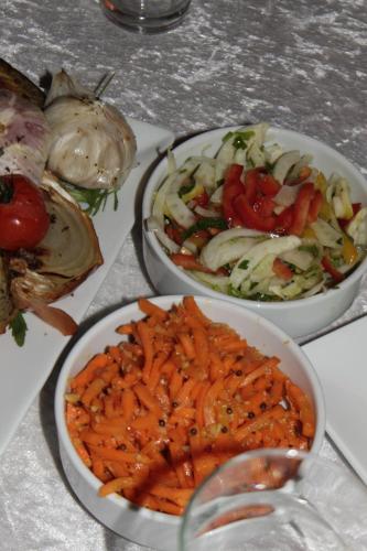 a table topped with three bowls of food with vegetables at Park Timna in Eilat