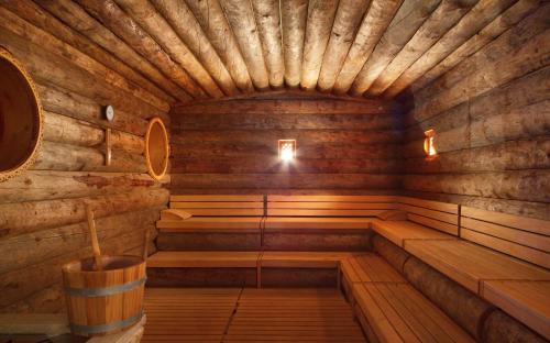 an empty wooden sauna with a barrel in it at Savoy Seychelles Resort & Spa in Beau Vallon
