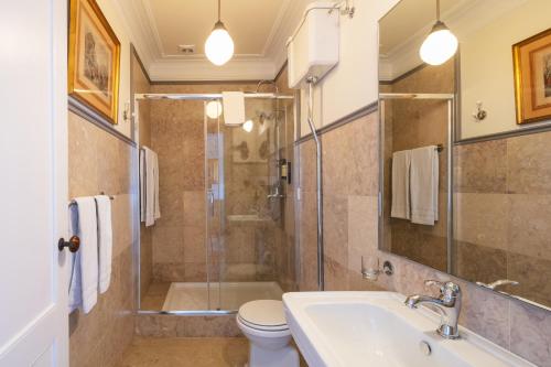 a bathroom with a shower and a sink and a toilet at Chalet Saudade in Sintra