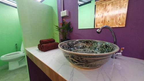 a bathroom with a sink and a toilet at Moonshine Resort Chumphon in Chumphon