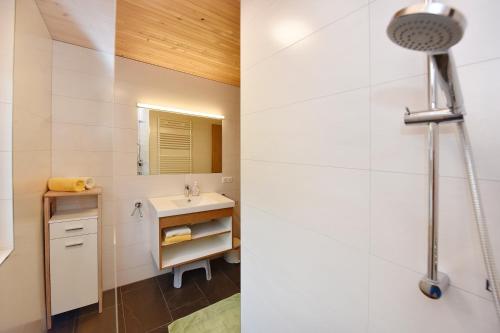 a bathroom with a sink and a mirror at Ferienhof Felder in Bezau
